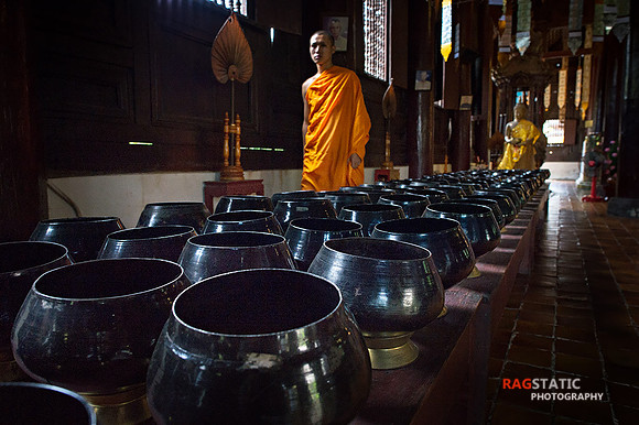 A Monk walks across the hallway.